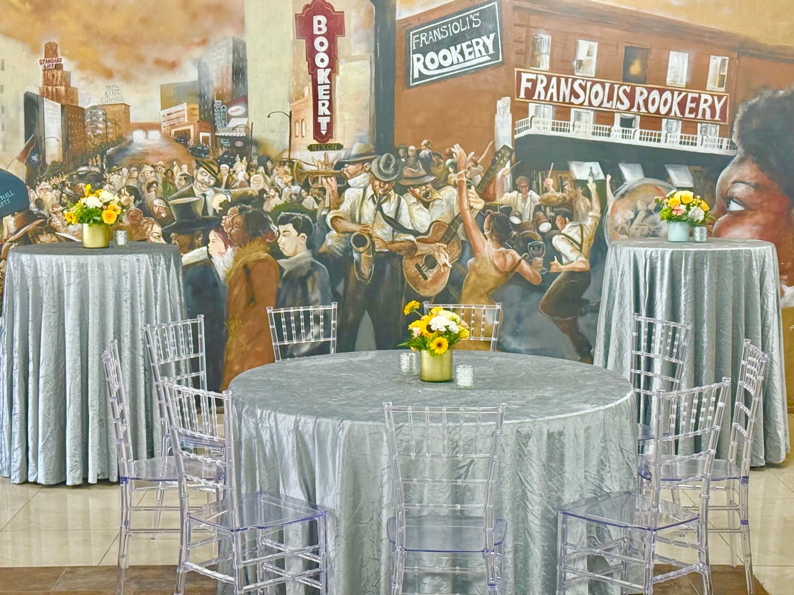 Reception tables in front of the historic Jackson mural